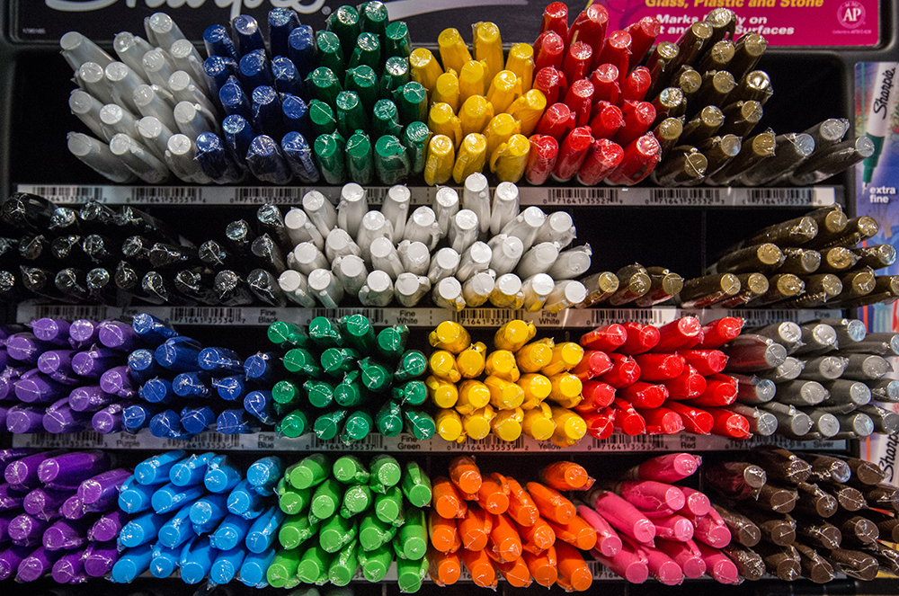 Colorful photo of markers bunched by color.