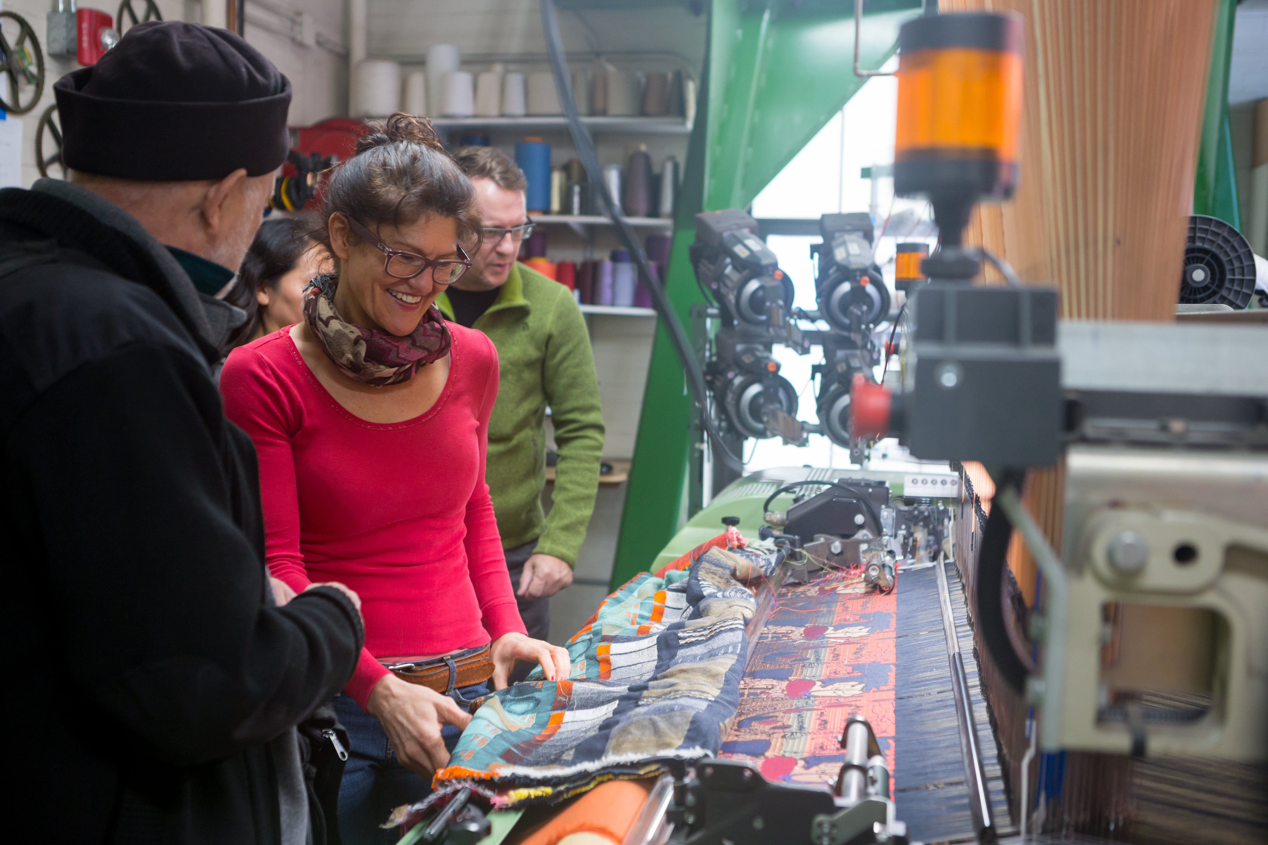 Polly Spenner 10 TX, a technical assistant for Textiles, demonstrates one of the looms during RISD Weekend 2019 open studios.