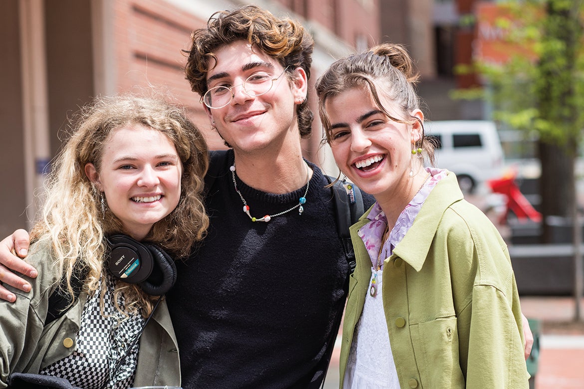Photo of three students standing together and smiling