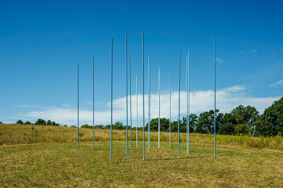 An arrangement of 17 blue and white reeds outdoors