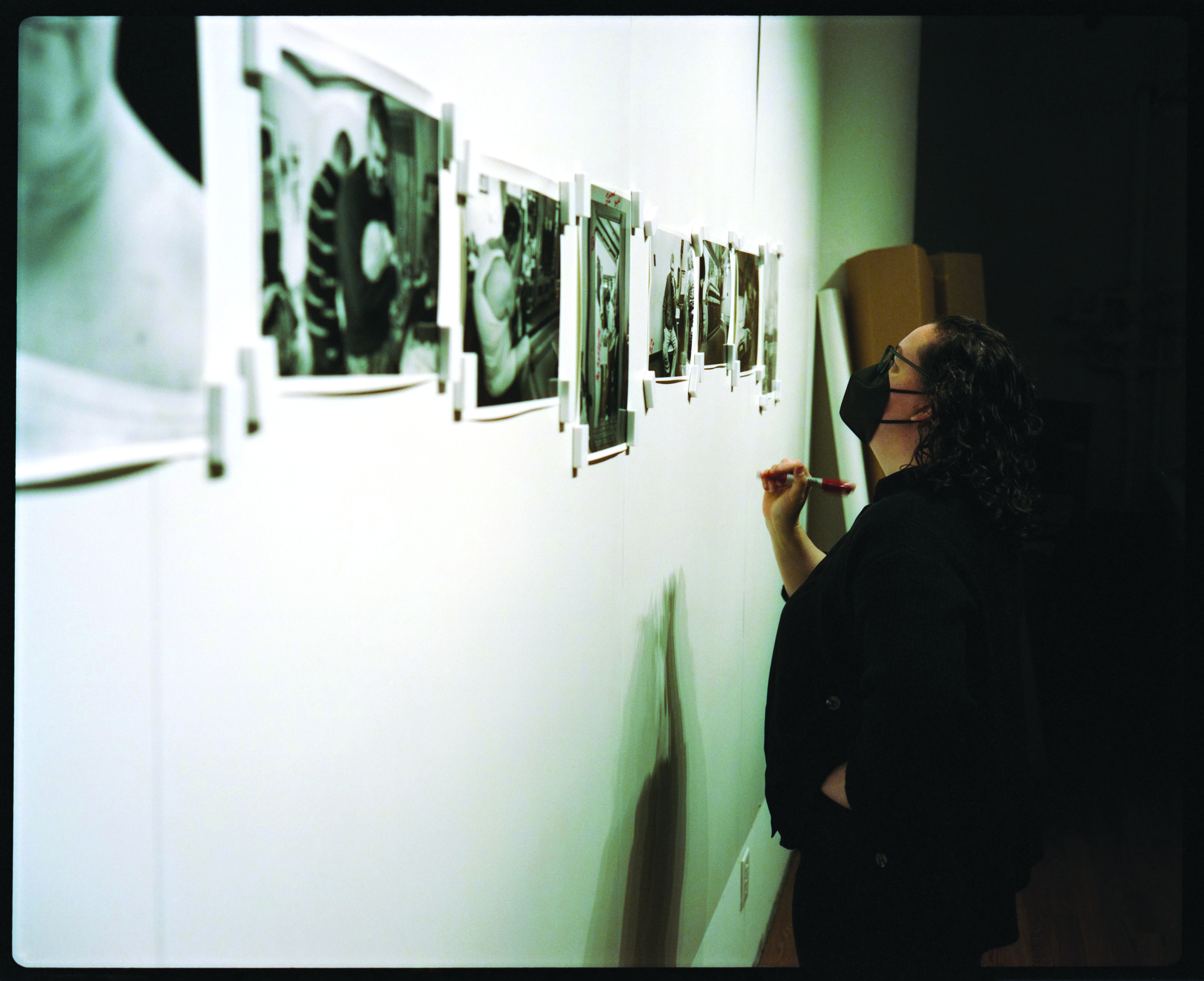 Photo of Jennifer Judkins selecting prints. Photo by Ian McAlpin