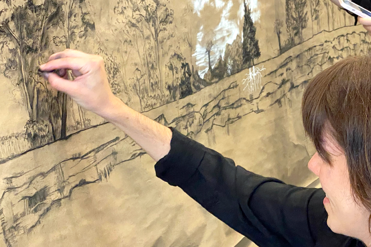 Student sketching a landscape