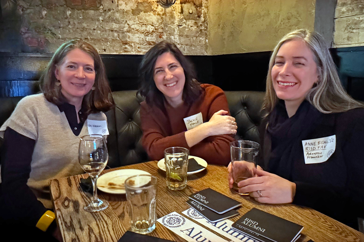 Alums around a table in a bar