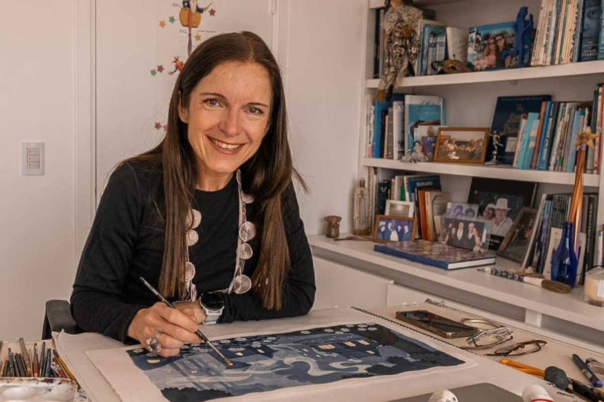 Dolores Avendaño sitting at her workstation smiling for the camera