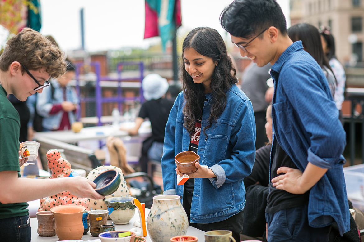Photo of students at an art sale on campus.