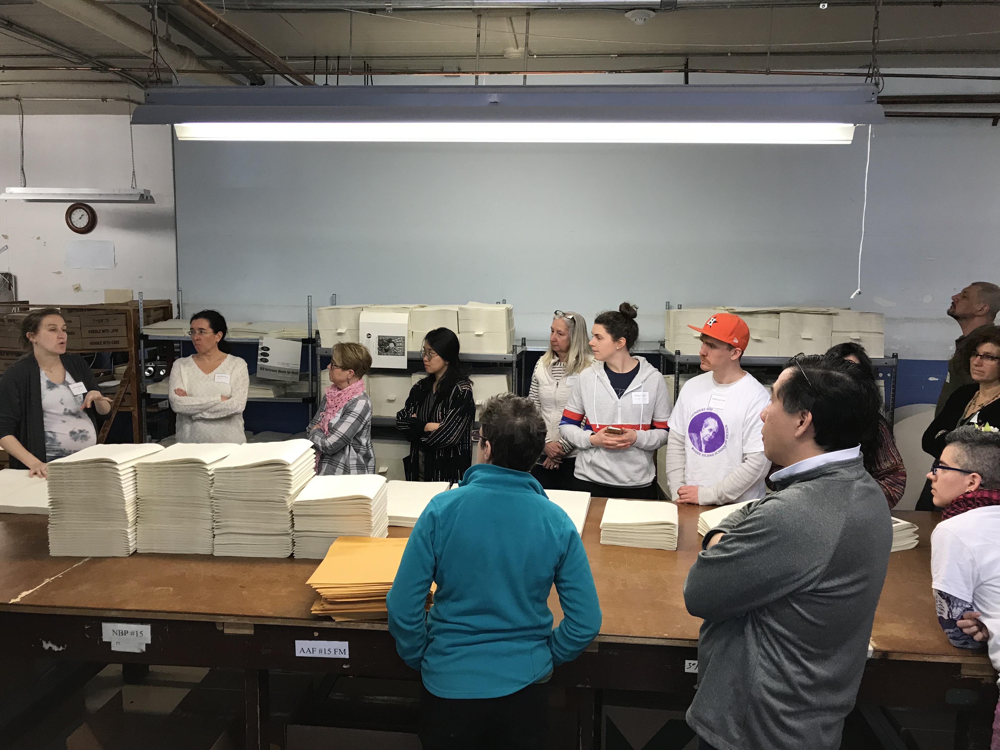 Photo of RISD alumni assembling braille books as part of their #RISDServes project in celebration of Founders Day 2019.