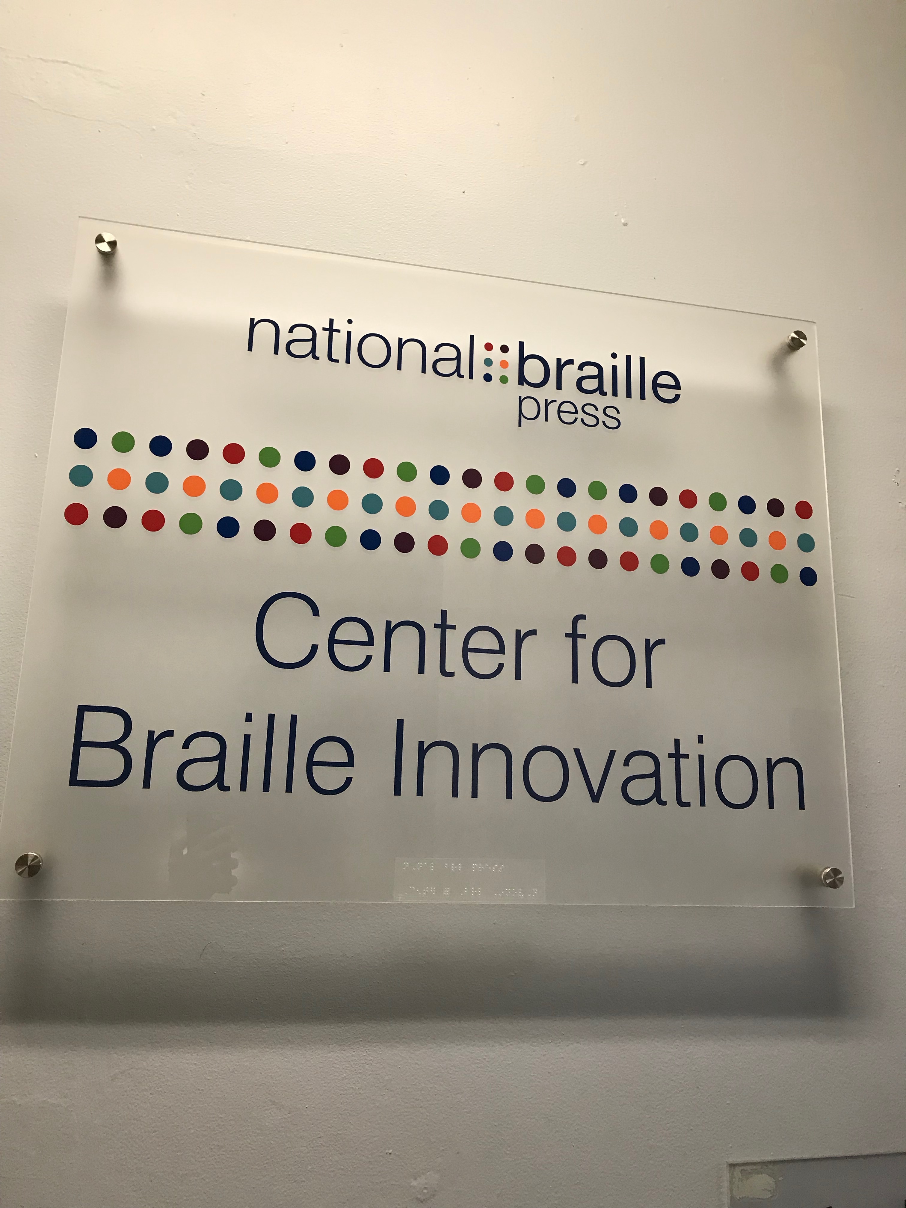 Photo of a sign that reads "National Braille Press - Center for Braille Innovation"