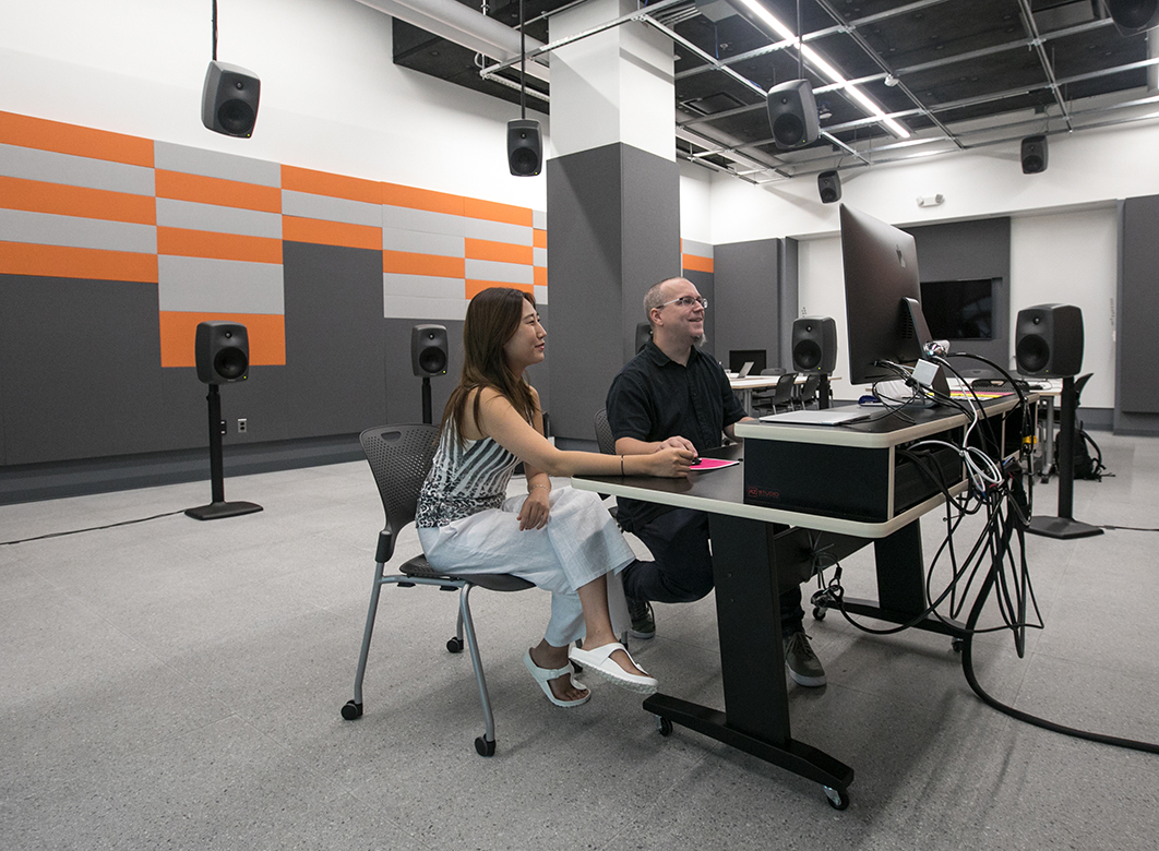 Photo of two people in the sound studio.
