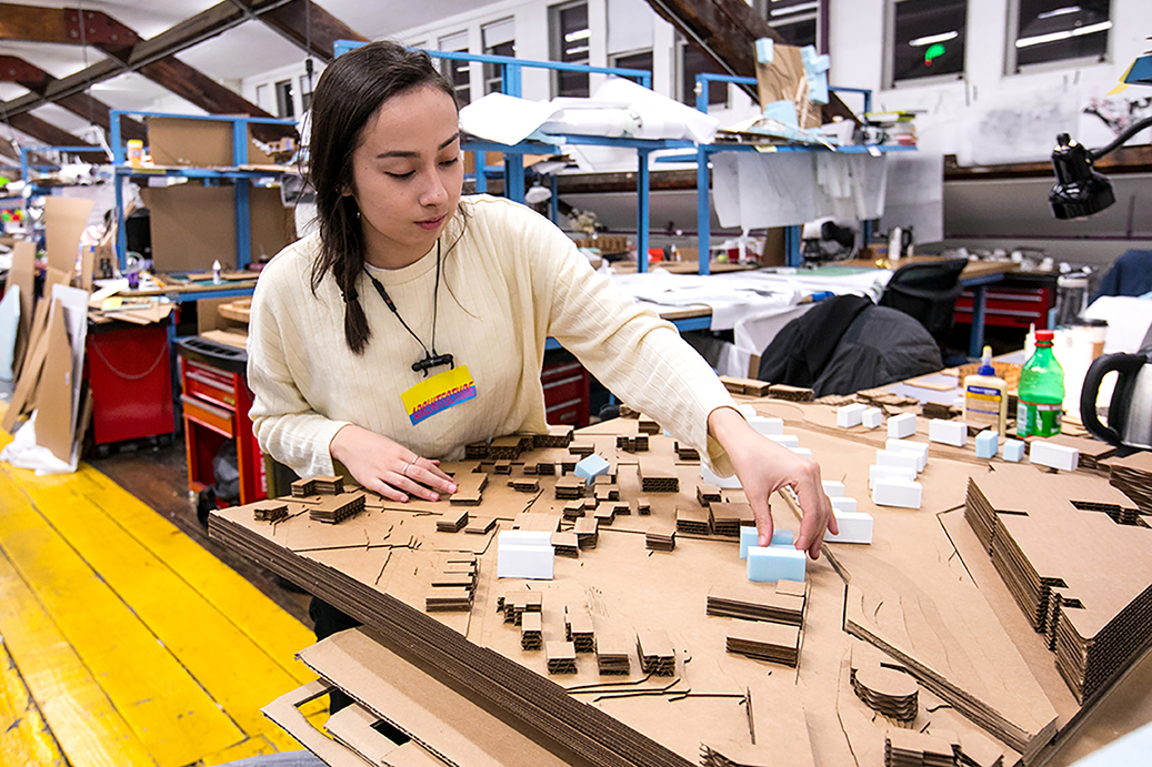 Architecture student working on model.