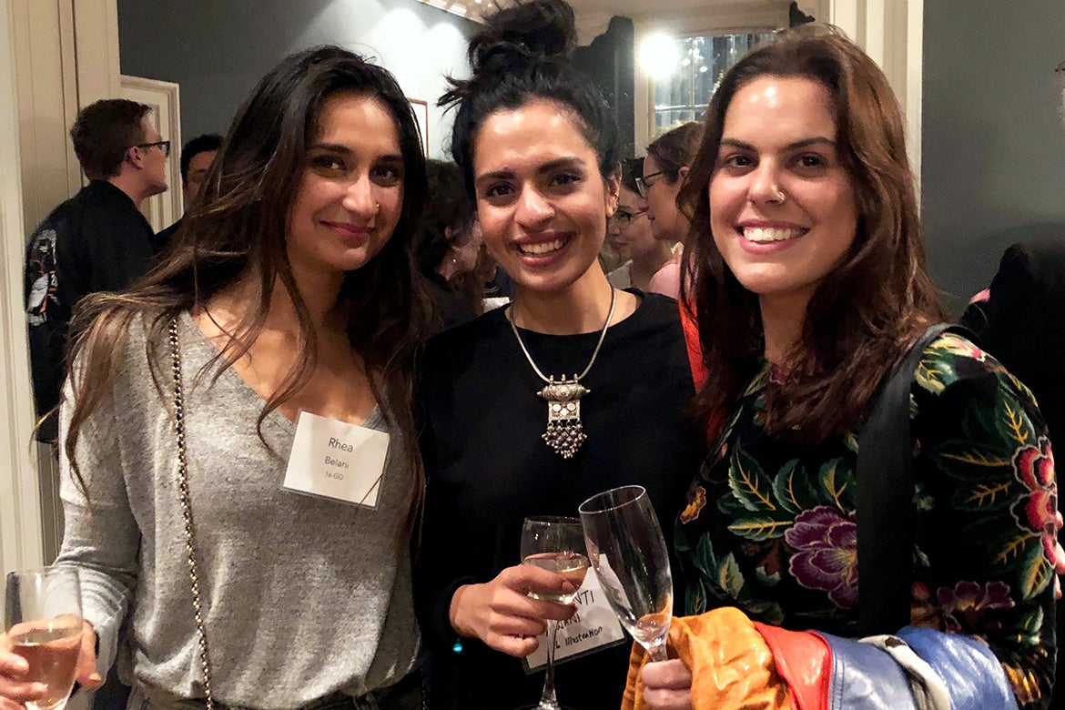 Photo of four alumni standing together at a reception in London