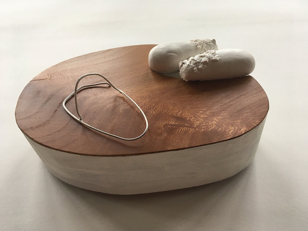 Photo of a sculpture by the artists made with wood, stone and other material