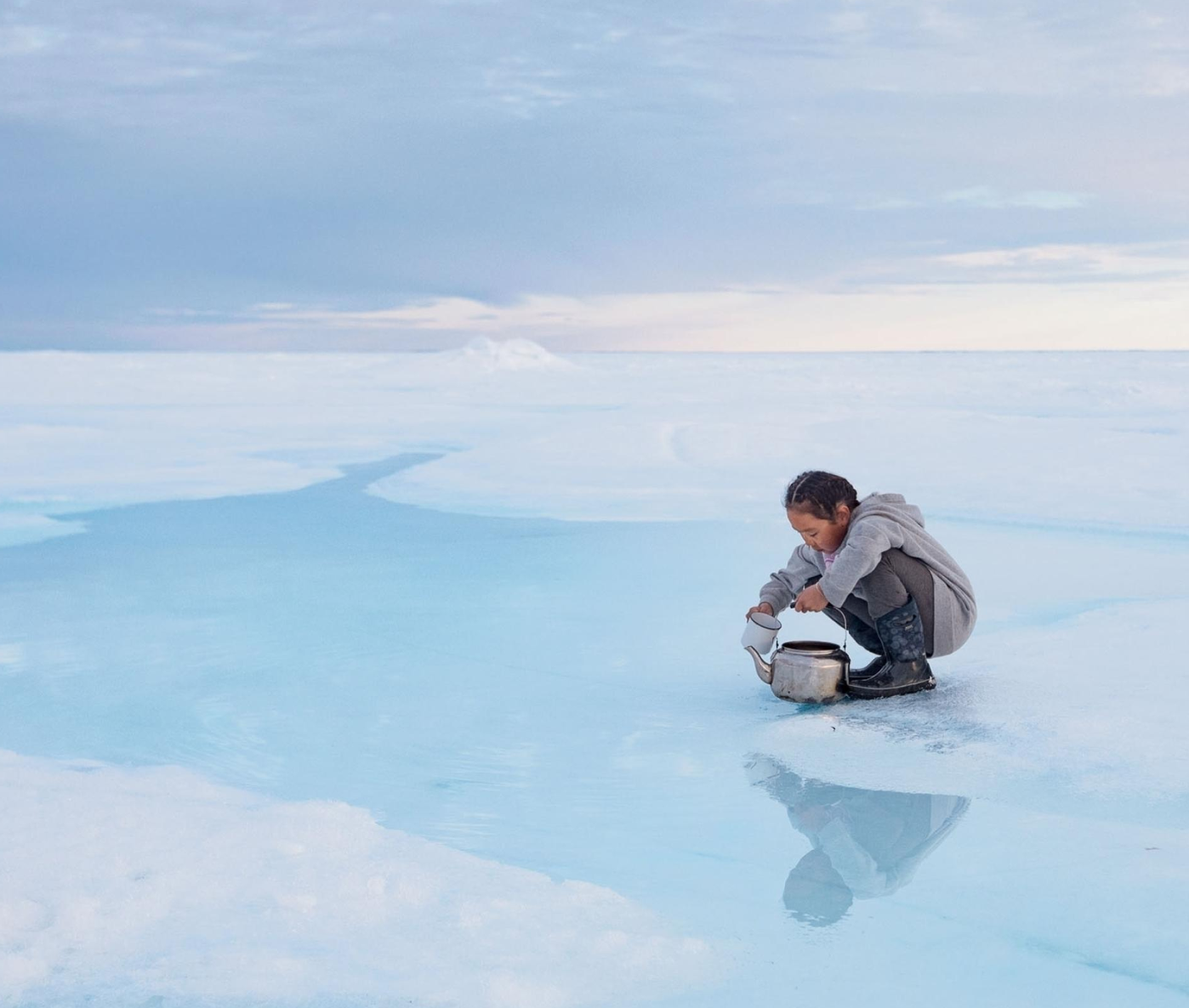Charlotte Naqitaqvik collects a teapot of water at her family’s hunting camp in Nuvukutaak, near the community of Arctic Bay in northern Canada.