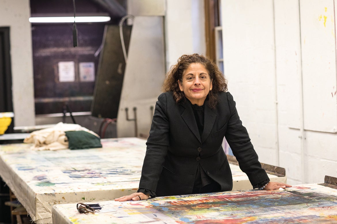 Photo of Anais Missakian at a studio table. 