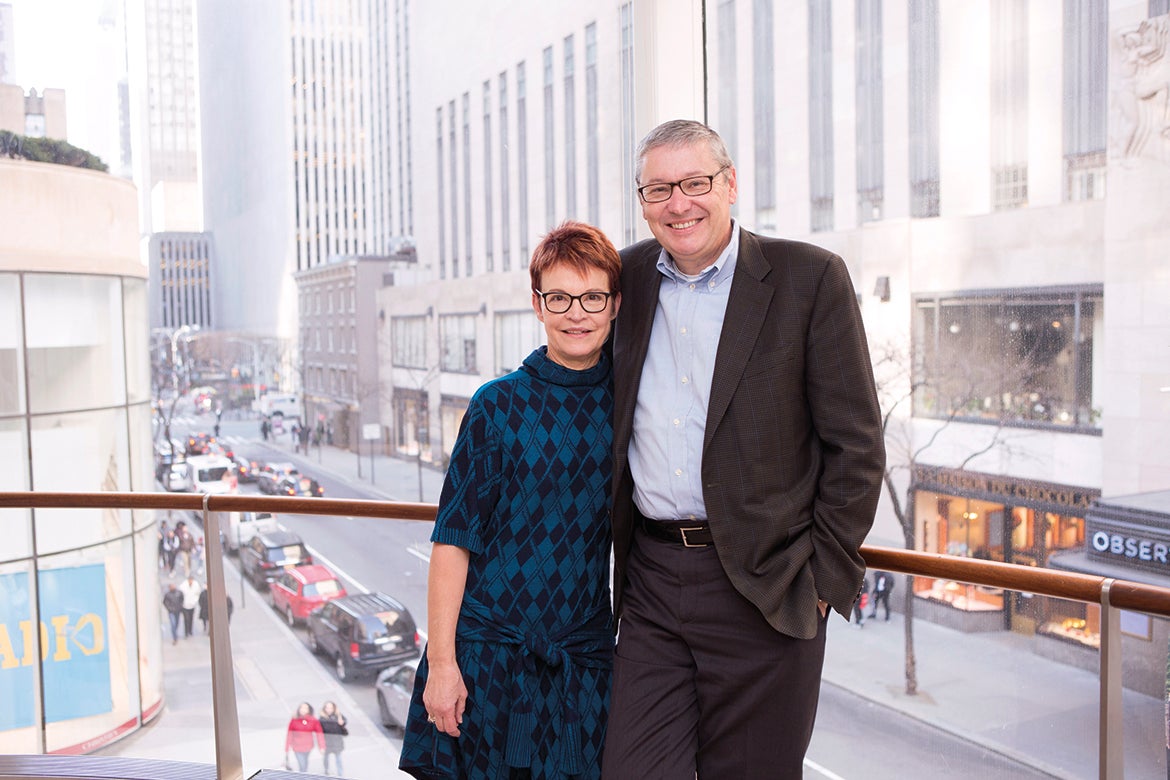 Photo of Deb and Greg Mankiw posting on a balcony.