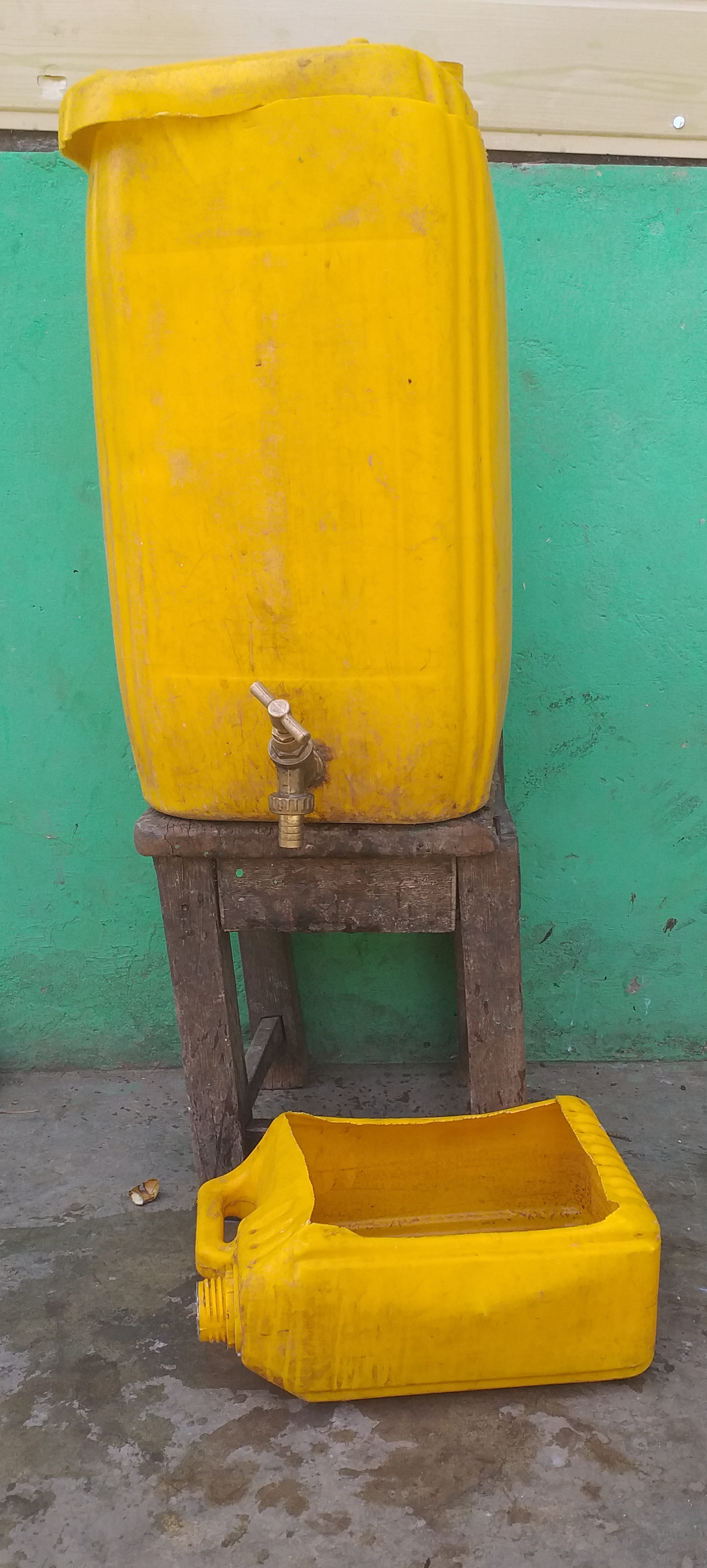 Photo of a Stephen Bucket made of plastic and a wooden chair. 