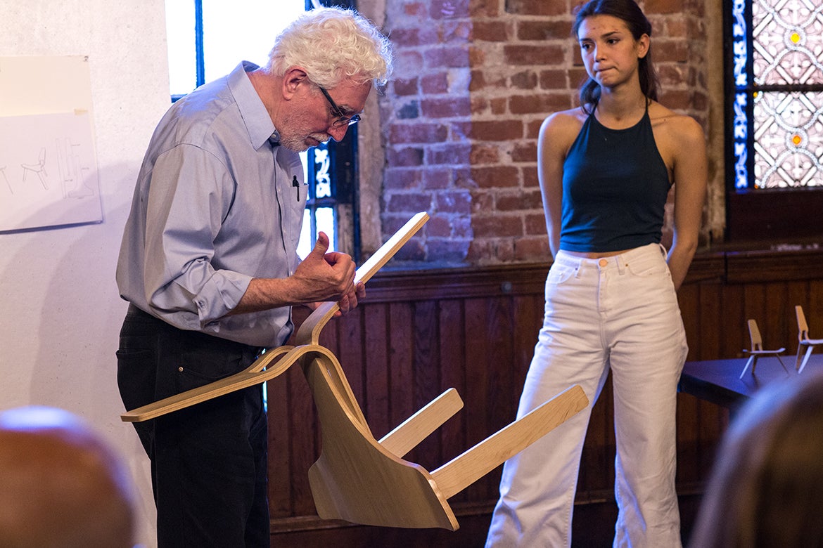 Photo of John Dunnigan examining a student's work