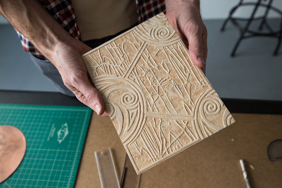 Nick Costantino showing a printing block he made.