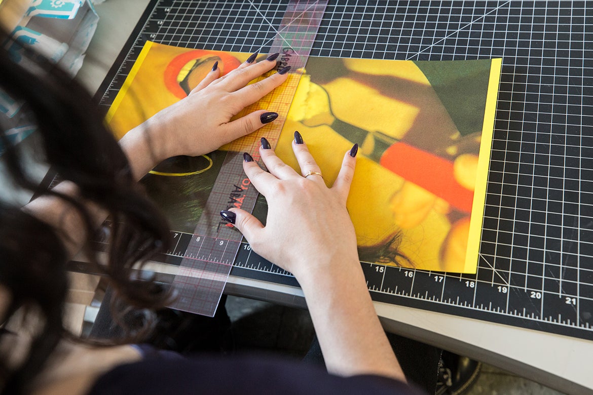 Photo of Xiomara Espana working on a zine