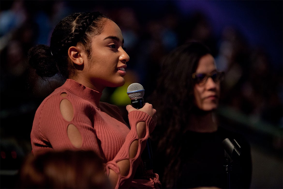 A woman holding a microphone.