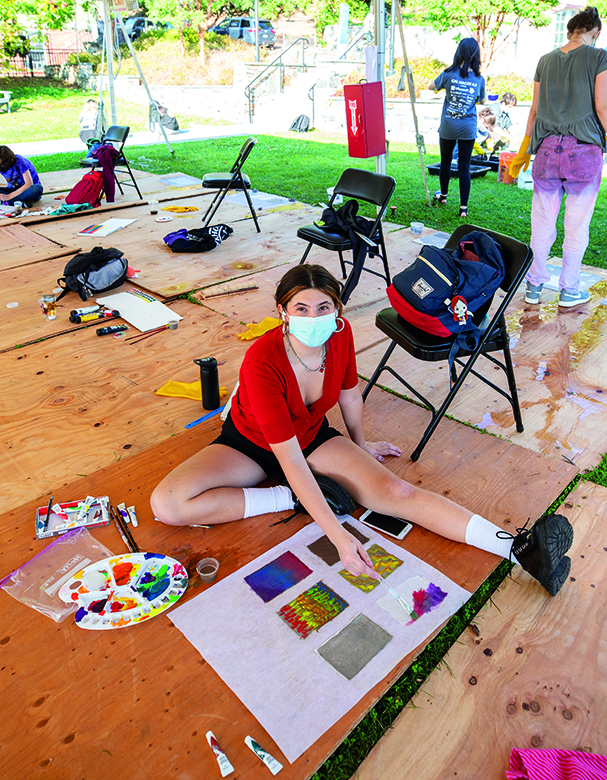 Image if a RISD student working on an art project outside