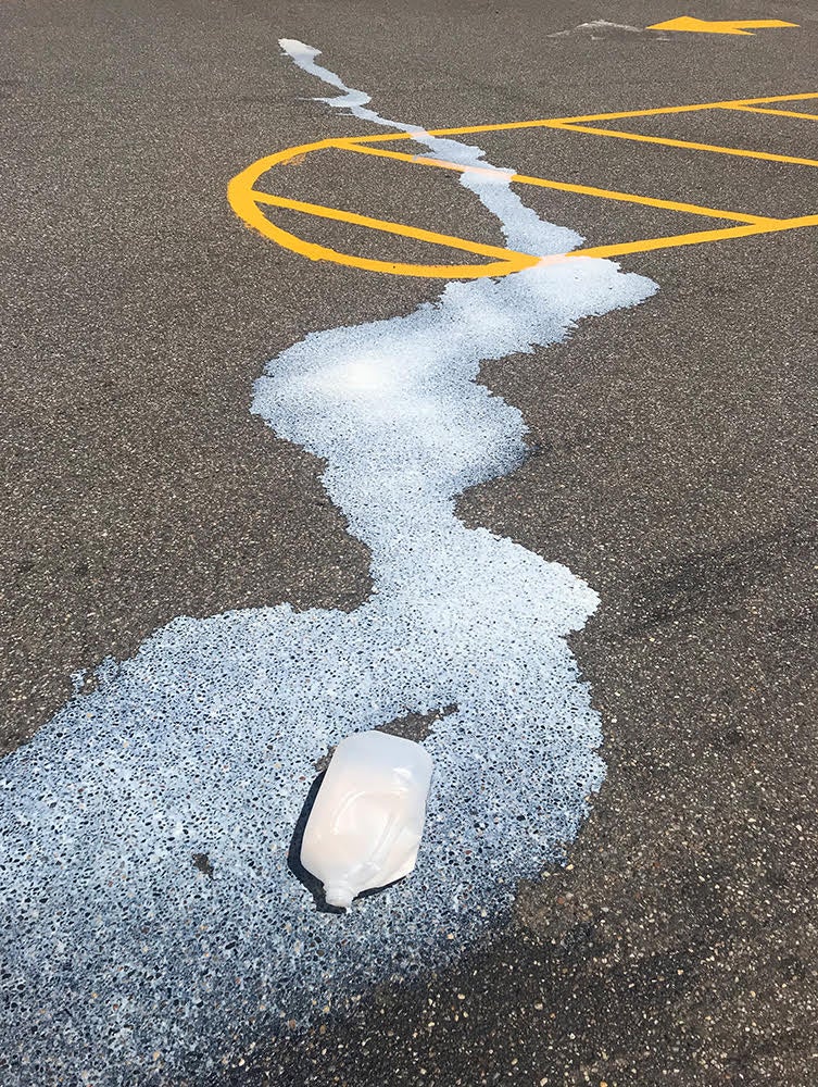 Image of a spilled milk carton in a parking lot