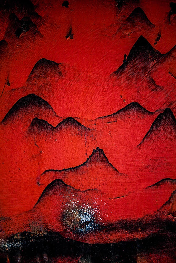 Abstract image in red with black mountain shapes