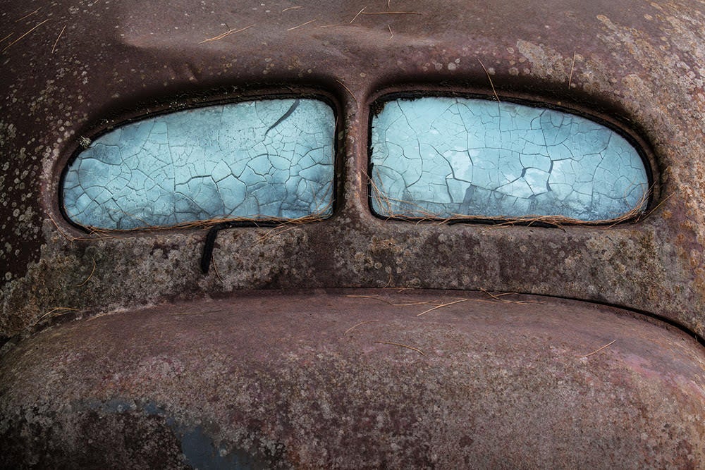 Detail image of the back of a deteriorating classic car 