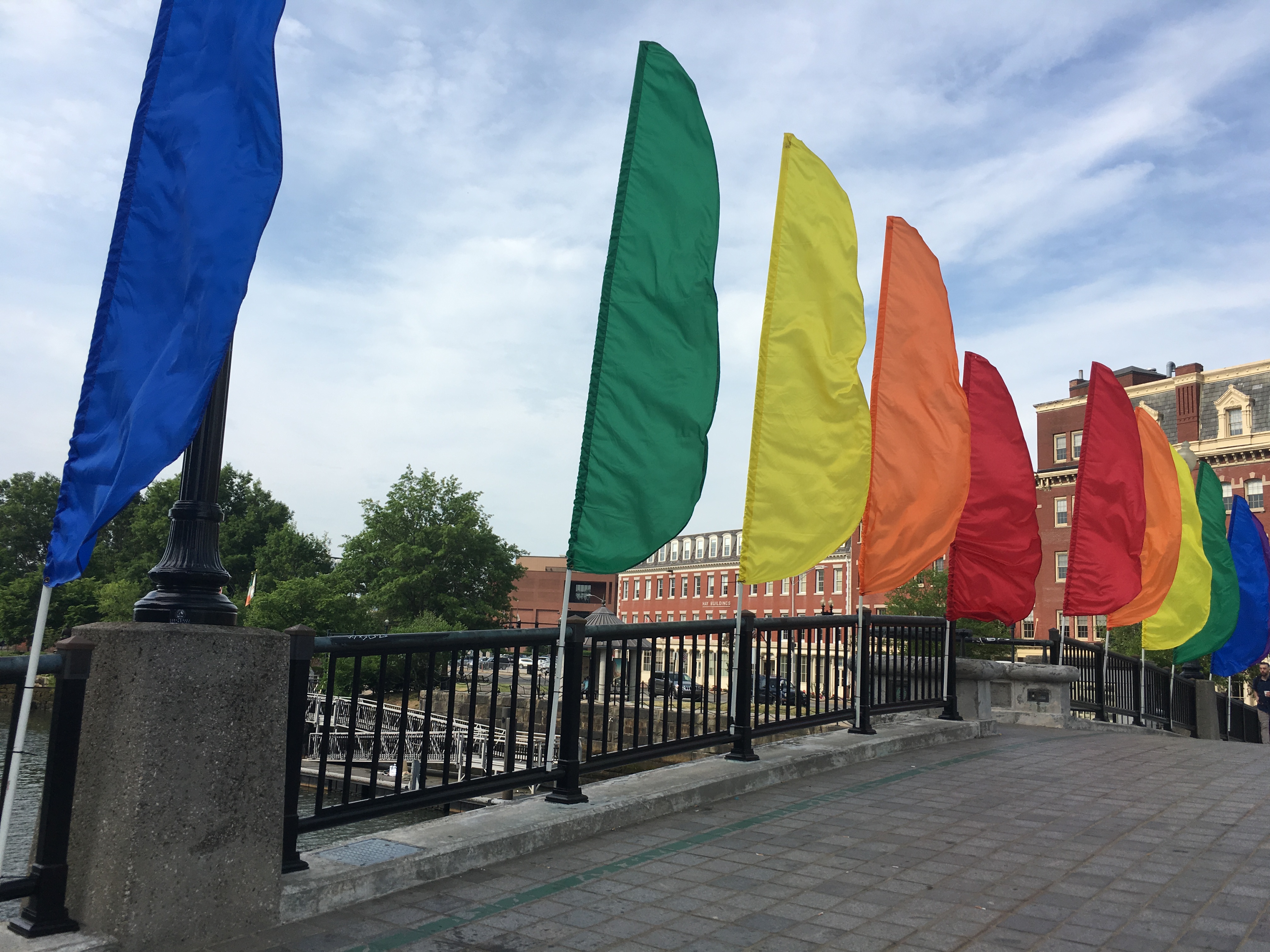 Image of rainbow flags across a bridge