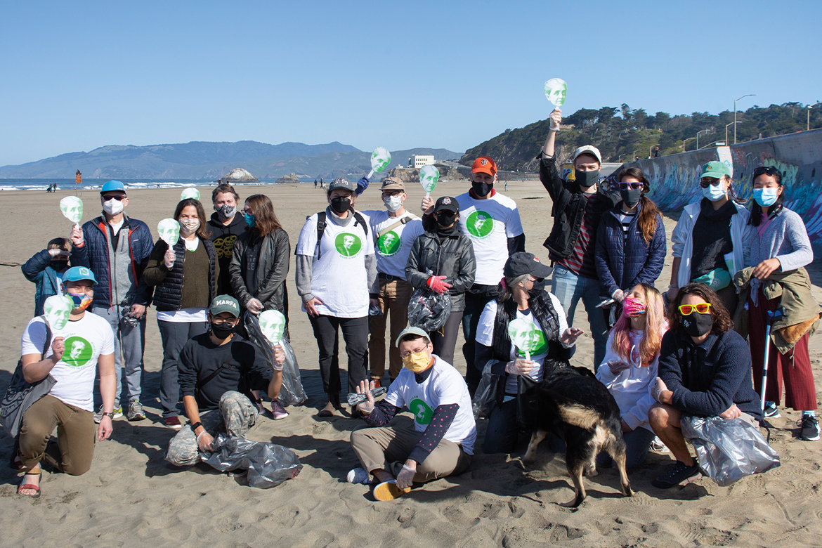 A large group of people standing on a beach 