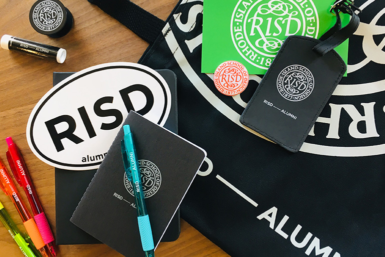 Image of RISD memorabilia such as keychains, luggage tags, pens