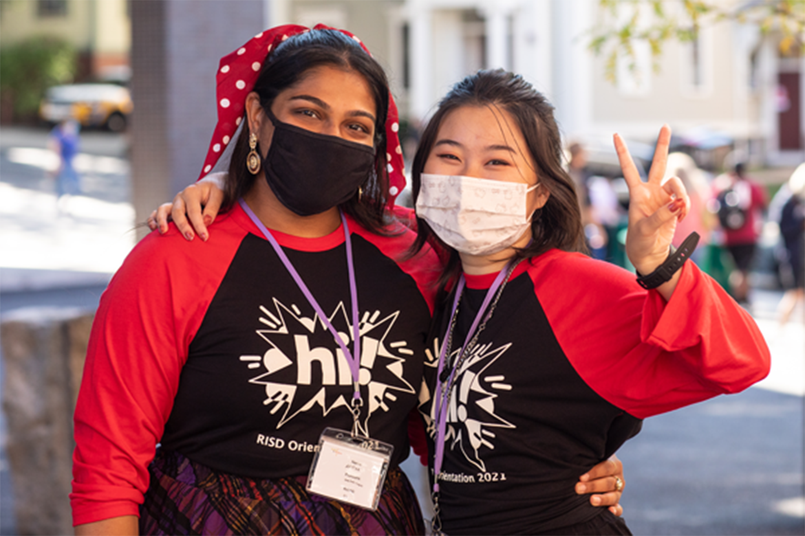 Two student volunteers in masks during orientation 