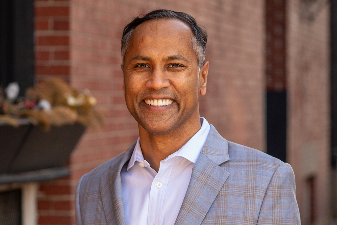 Image of a man in a grey plaid suit