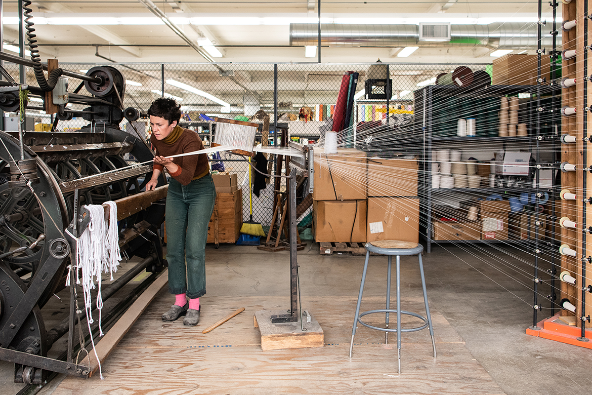 Person working on an industrial loom