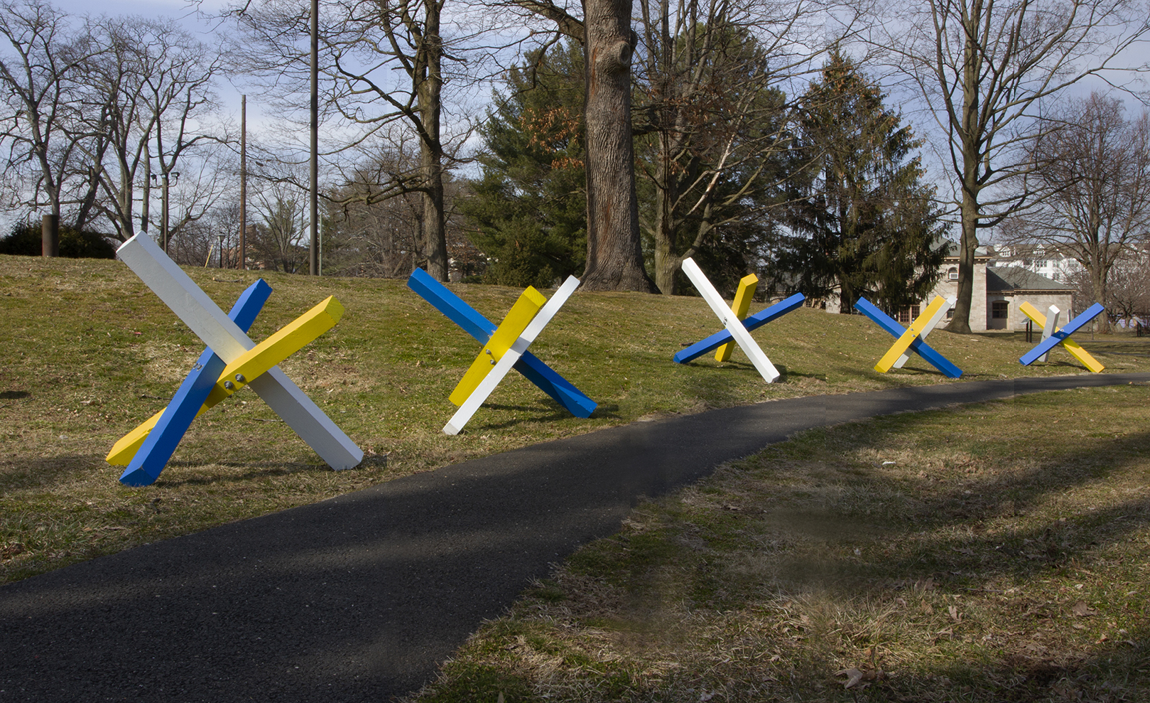 A row of blue, yellow and white structures on a field