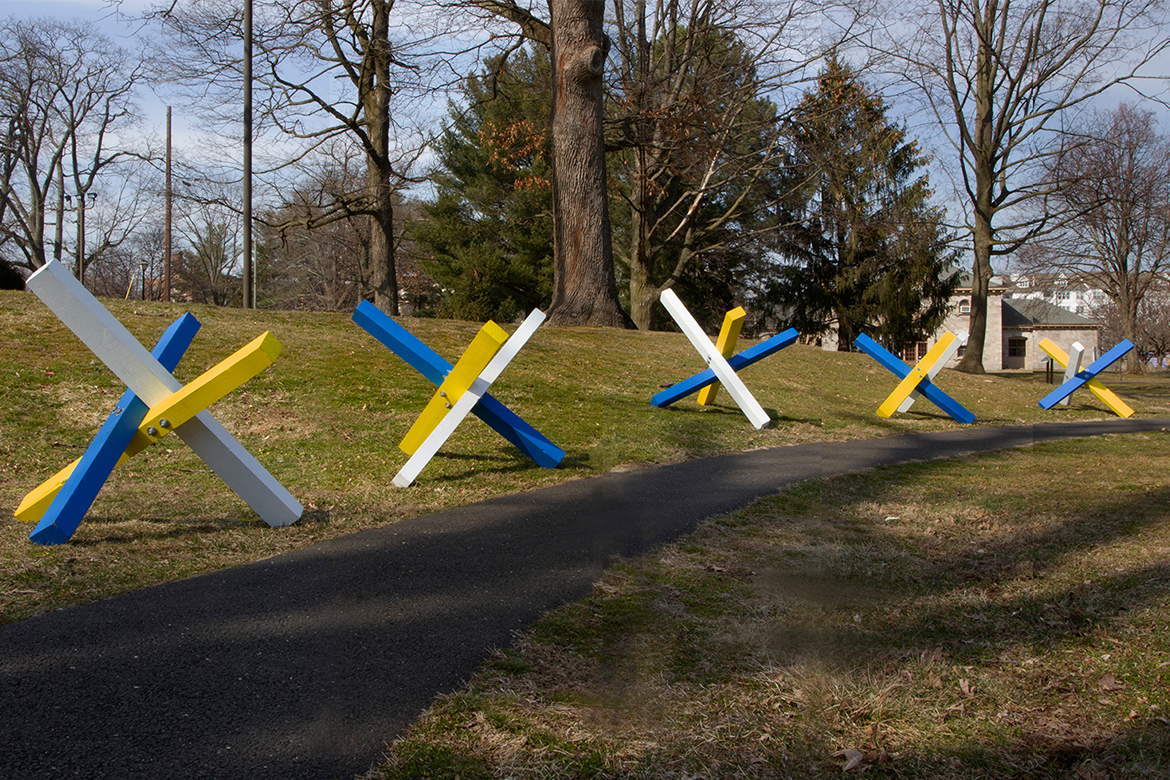 Blue, white, and yellow sculpture on a field