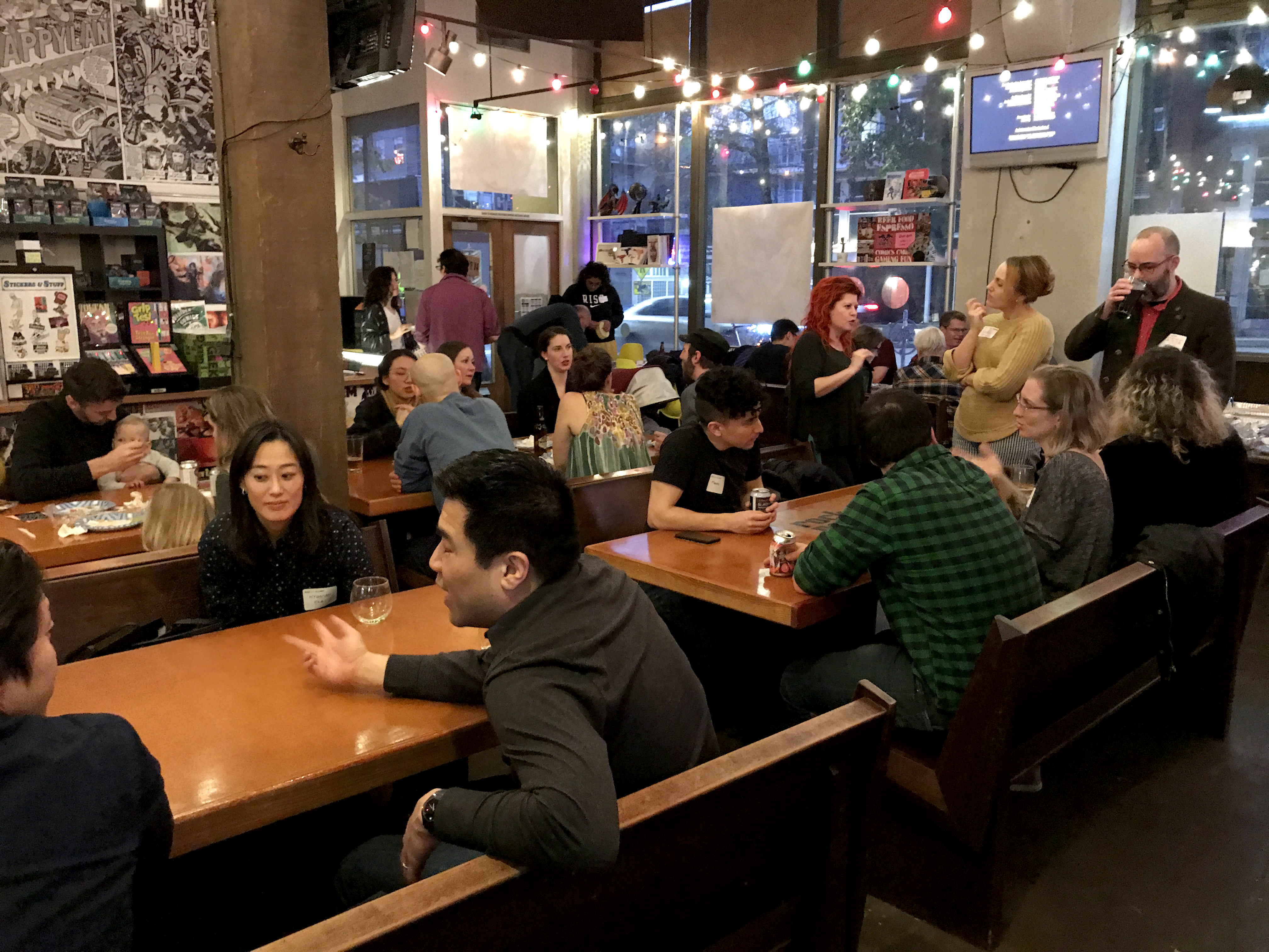 Groups of people conversing at restaurant tables