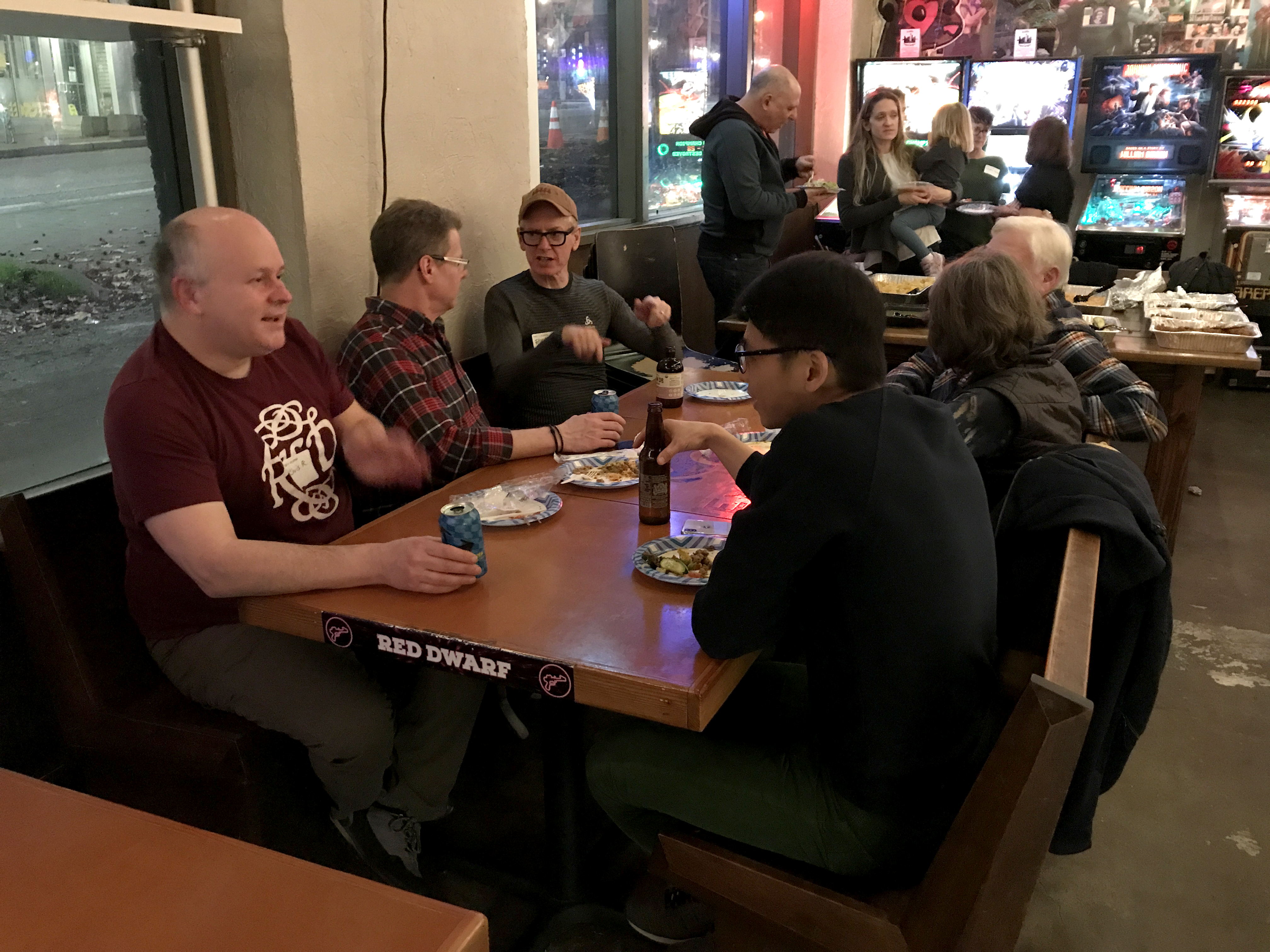 A group of people conversing at a restaurant table