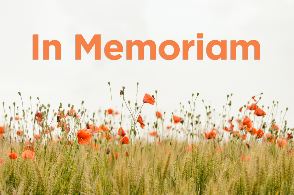 Orange text that reads In Memoriam above a field of poppies