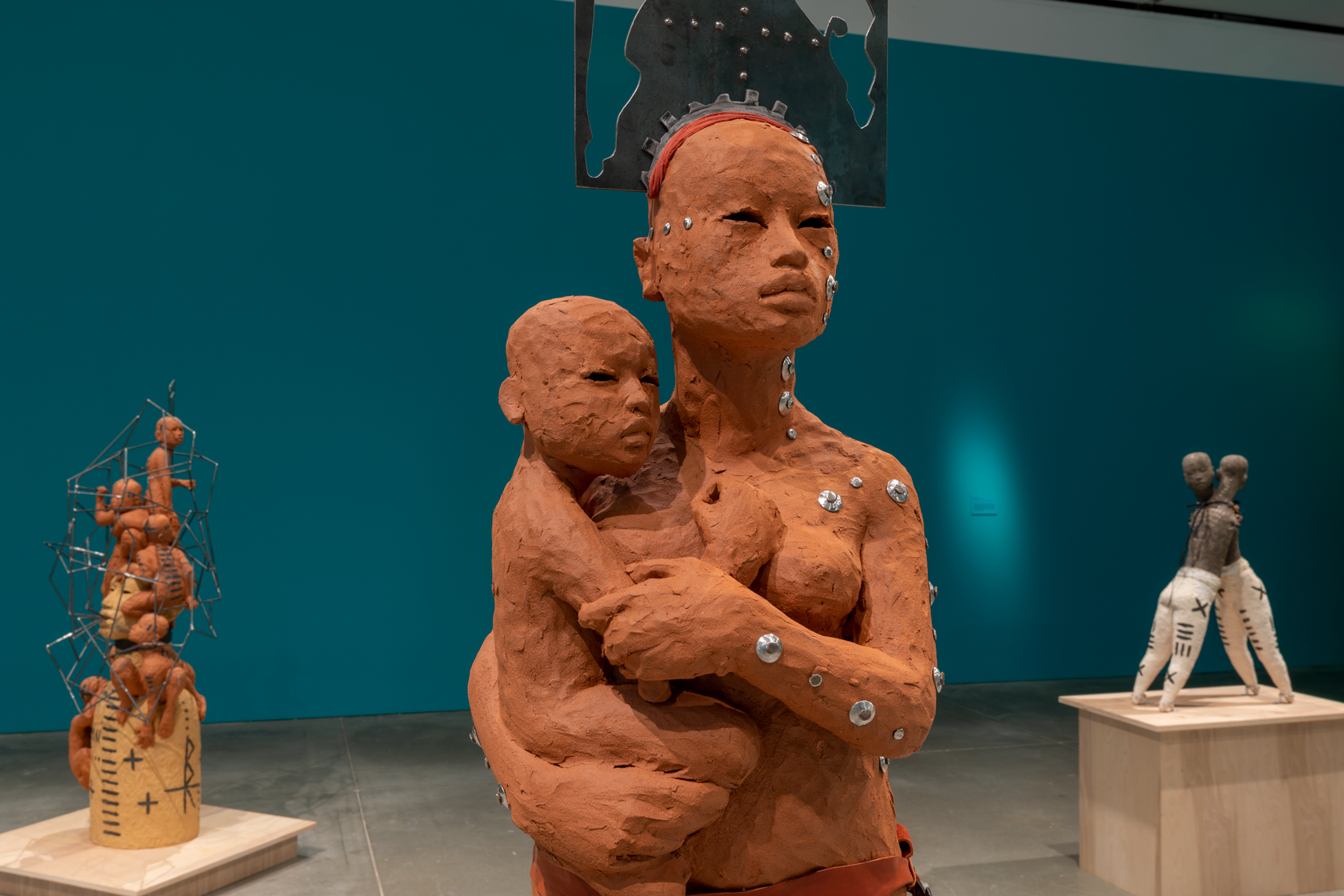 A clay woman holding a clay child