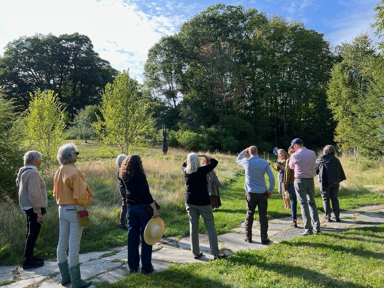 Ten people standing on an outdoor path