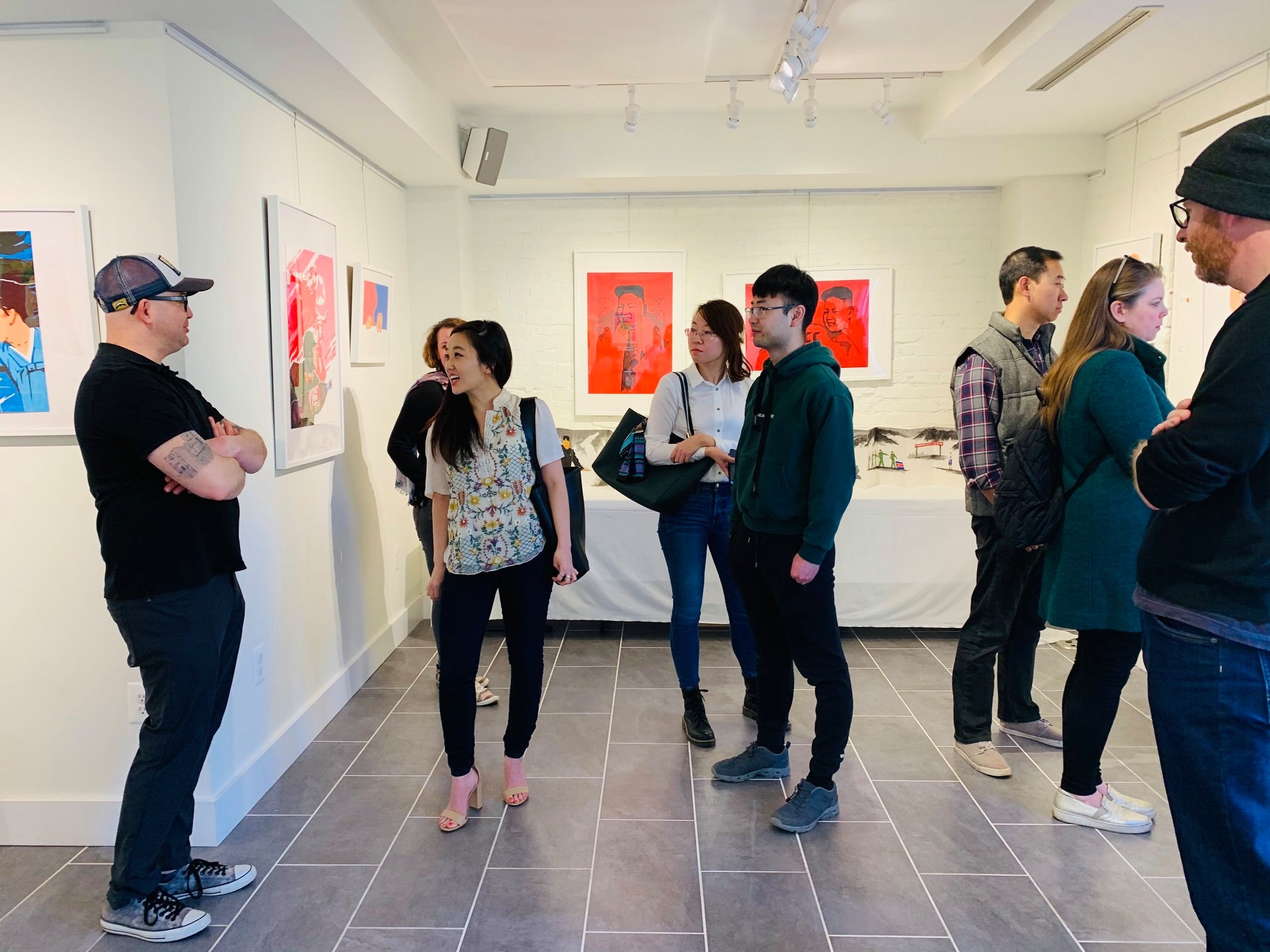 A group of people standing in a gallery