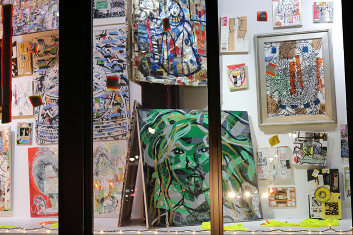 A collection of multicolored paintings in a window