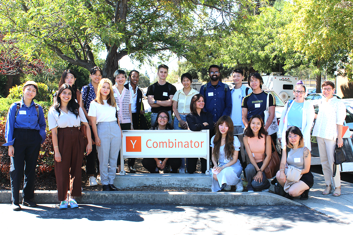 A group of people standing outdoors and smiling for the camera