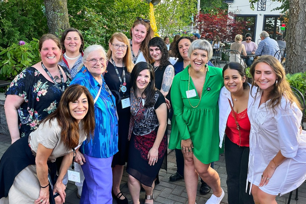 A group of women smiling outdoors