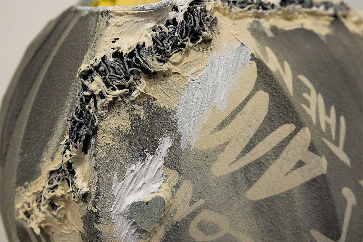 Combined gray and tan material marked with tan writing and white paint