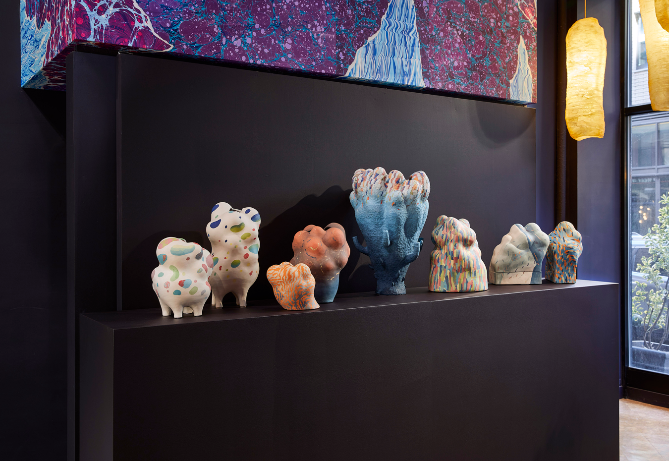 A shelf of multi-colored vessels