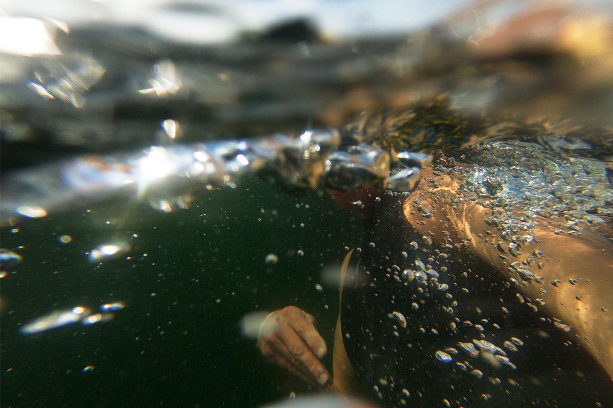 A photograph of a man swimming