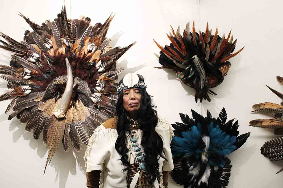 Cynthia pictured beside her works of feathers