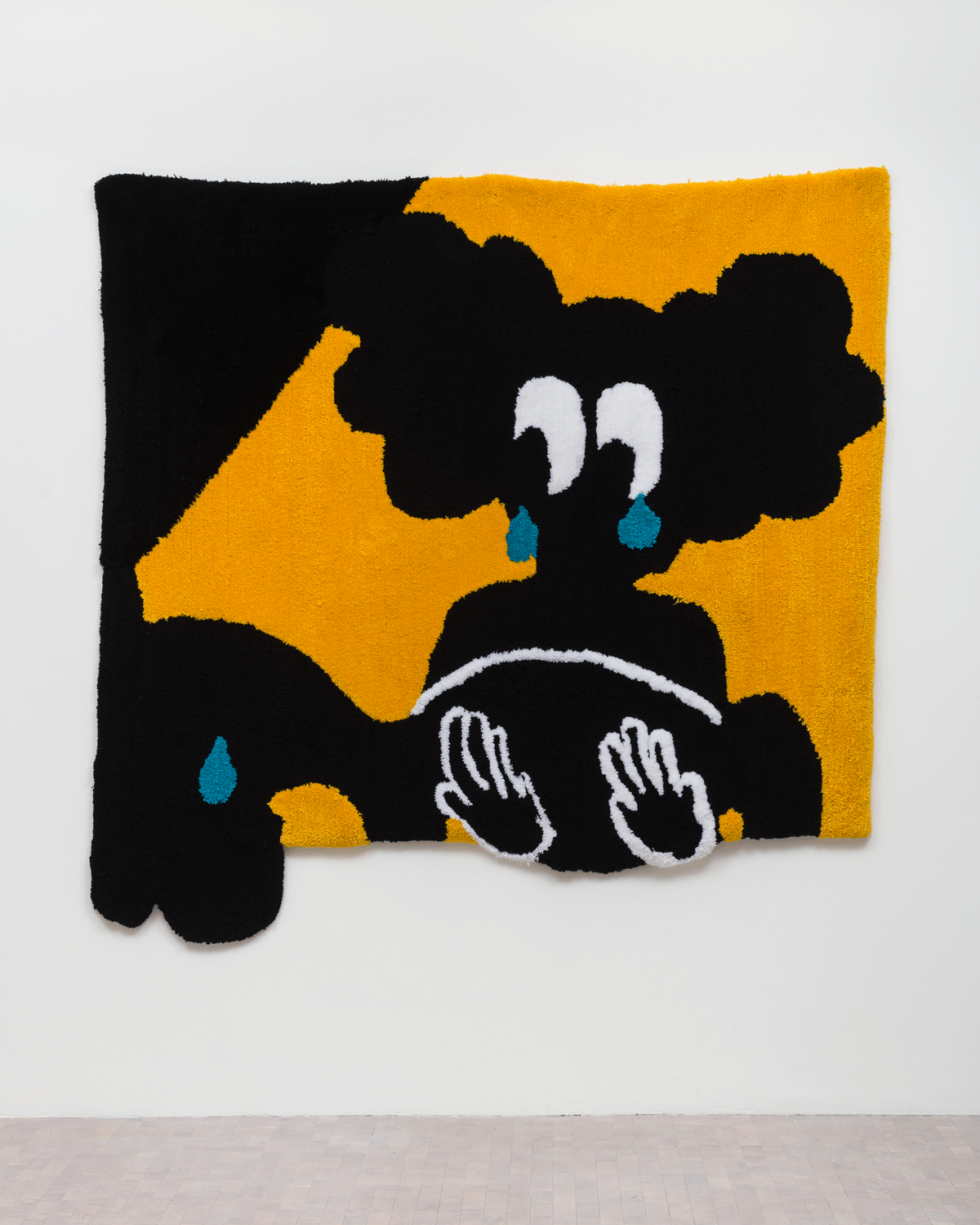 A tapestry of a crying person holding another crying person