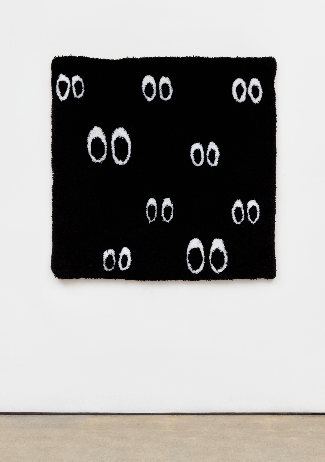 A cartoon-like tapestry of multiple pairs of eyes in the darkness